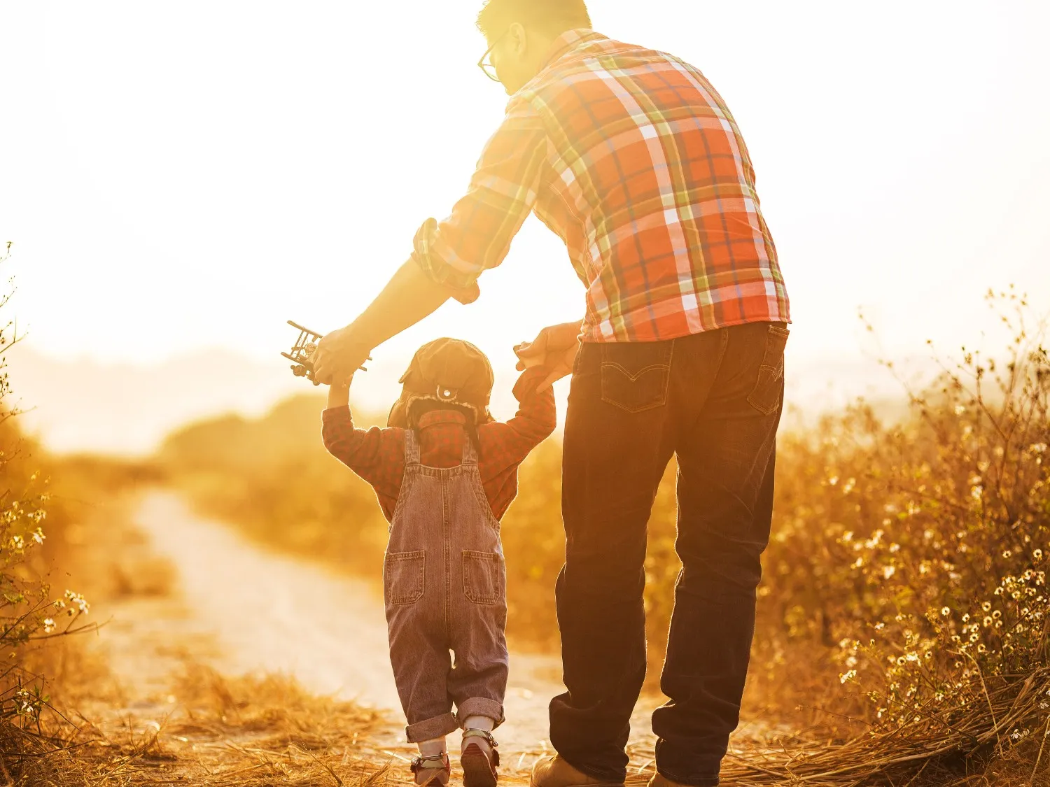 Father and child outside at sunset