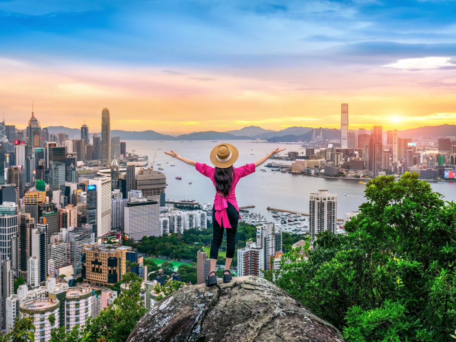 Hong Kong skyline and woman celebrating