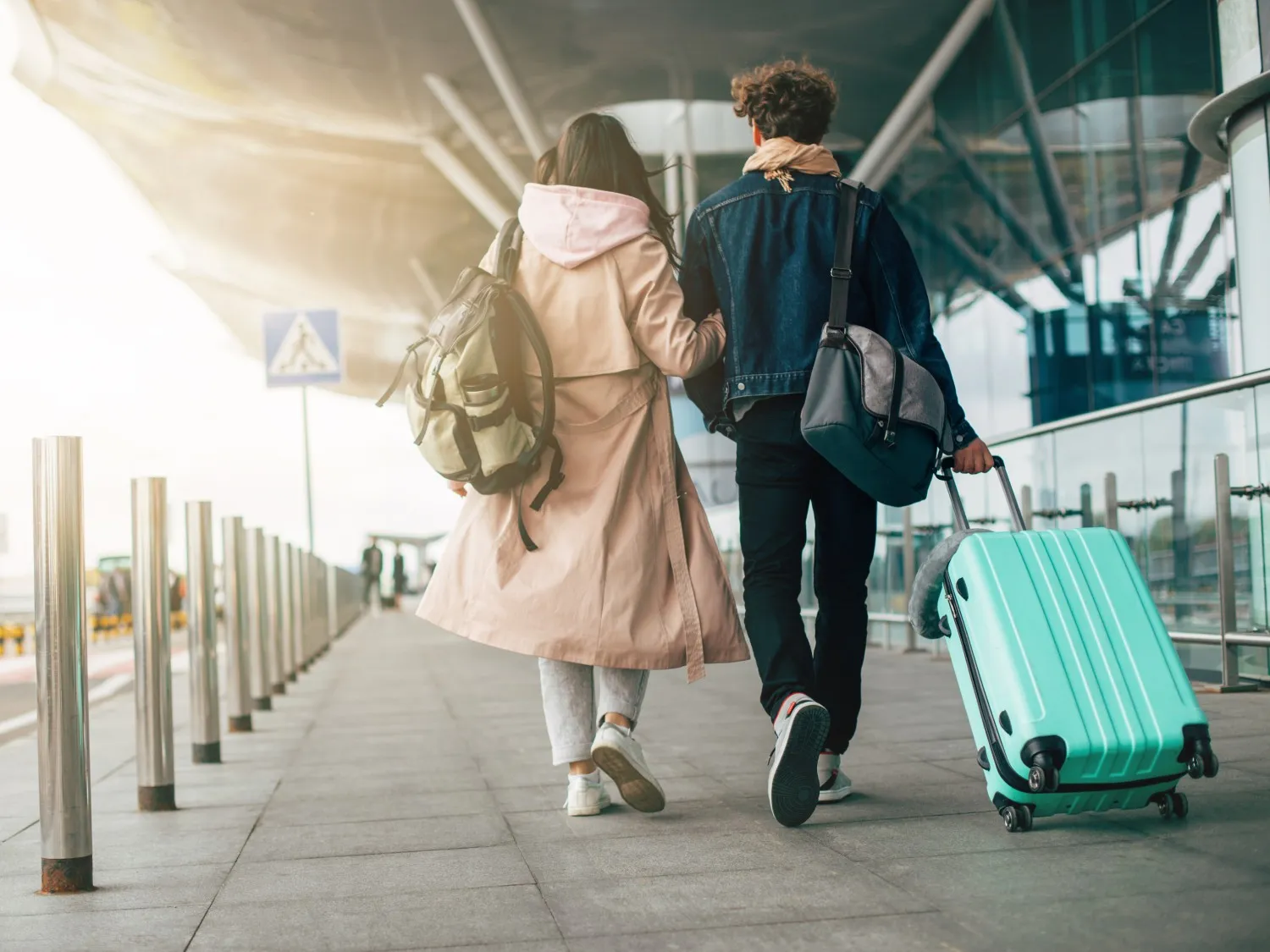 couple walking with a suitcase