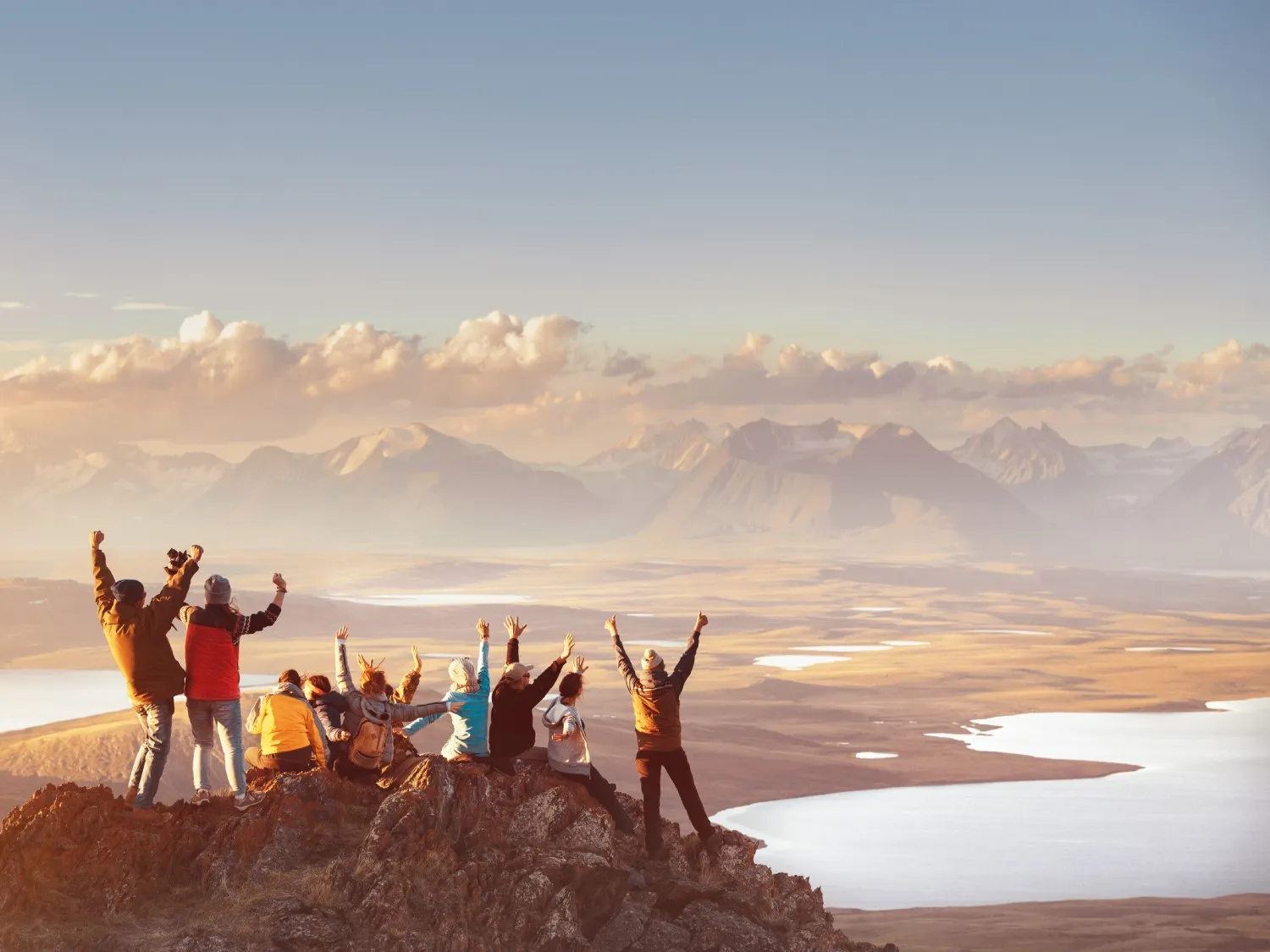 Group of happy friends having fun outside in the mountains