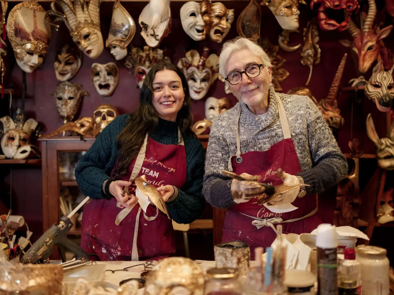 Two artisans painting Venetian masks