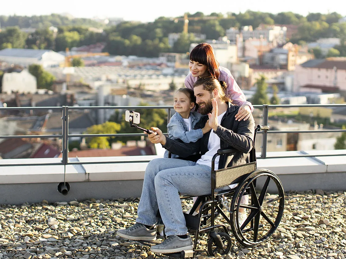 Family taking a picture with one member in a wheelchair